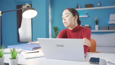 Asian-woman-gets-tired-while-working-from-home-and-puts-her-head-on-the-table-and-starts-to-think.